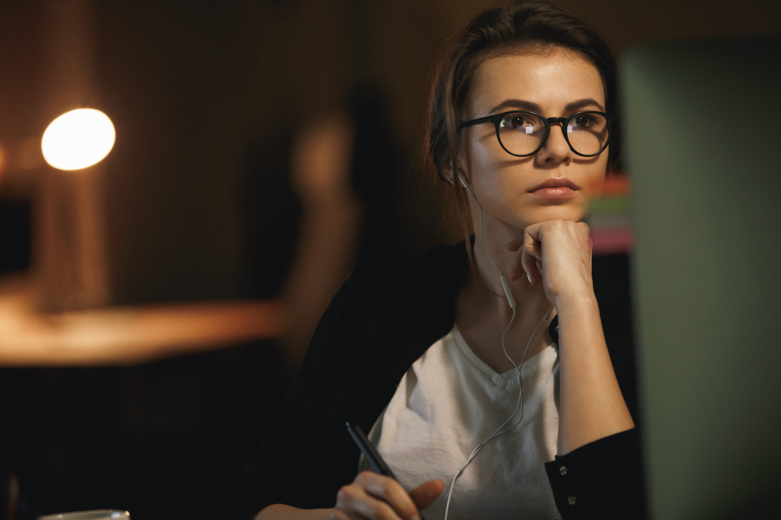 Woman designer in glasses using computer in office